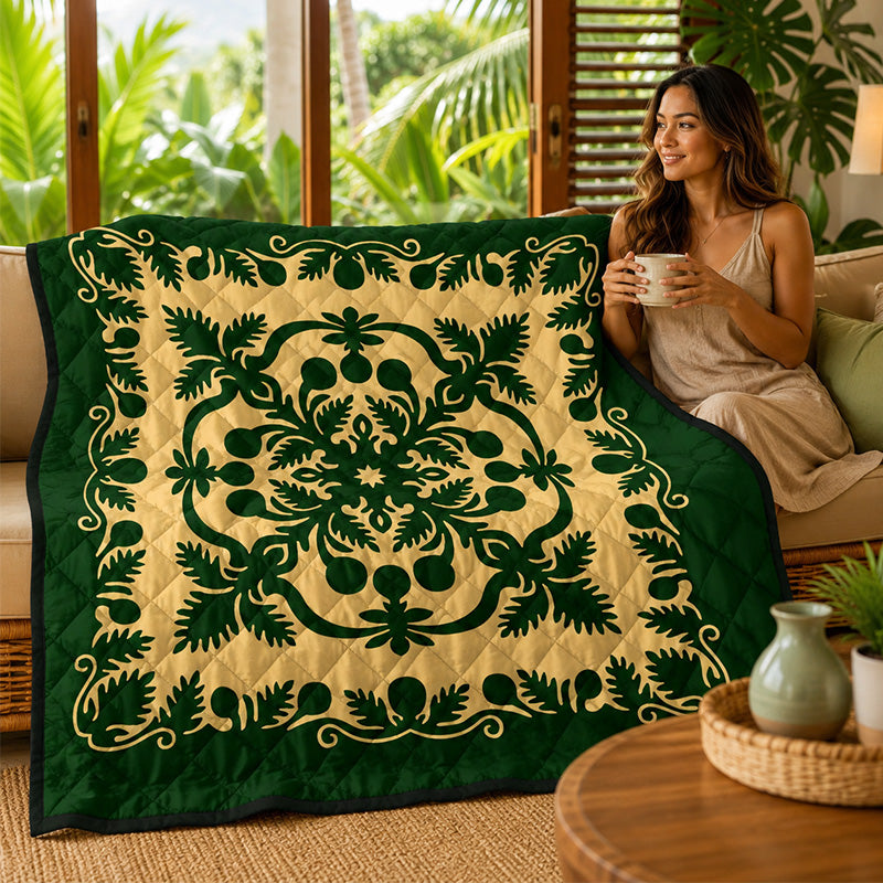 Woman sitting on a couch with a decorative green and beige Hawaiian quilt